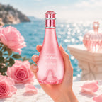 Hand elegantly holding the Davidoff Cool Water Sea Rose Eau de Toilette 100ml bottle against a soft ocean-inspired background with natural sunlight | Perfumesouq qatar
