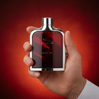 Man holding Jaguar Classic Red EDT perfume bottle | Perfume Souq Qatar