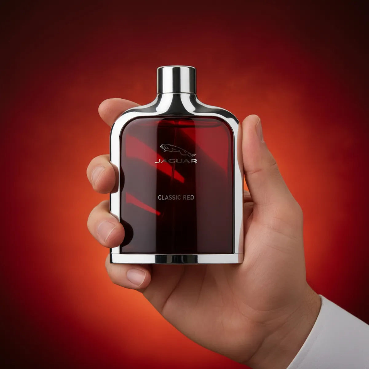 Man holding Jaguar Classic Red EDT perfume bottle | Perfume Souq Qatar