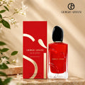 Giorgio Armani Si Passione Eau De Parfum 100ml vibrant red bottle standing next to its matching luxury red box packaging on a marble vanity surface perfumesouq qatar
